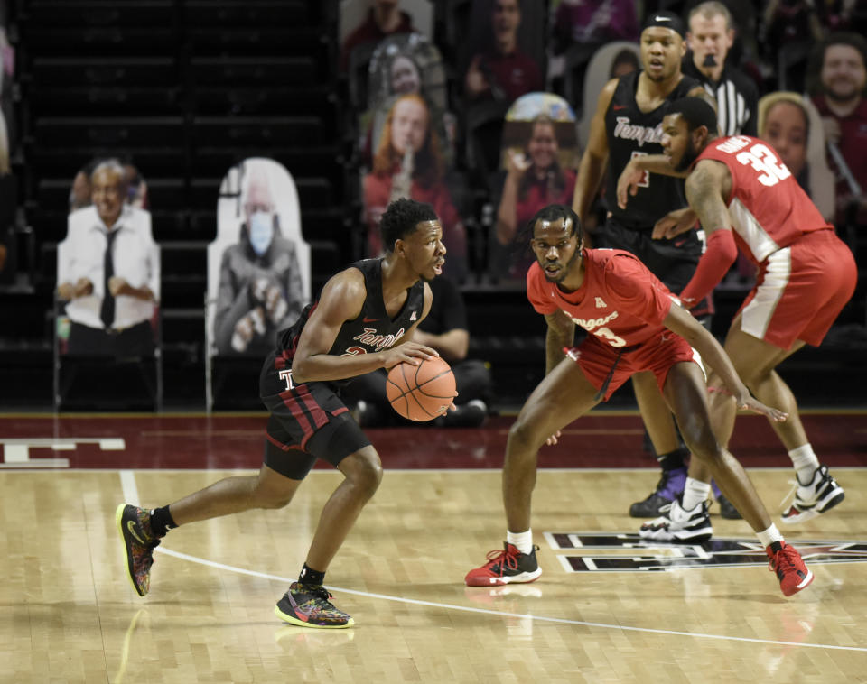 Temple's Jeremiah Williams, left, dribbles around Houston's DeJon Jarreau (3) in the first half of an NCAA college basketball game, Saturday, Jan. 23, 2021, in Philadelphia. (AP Photo/Michael Perez)