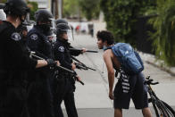 A man confronts police officers during a protest over the death of George Floyd, Monday, June 1, 2020, in Anaheim, Calif. Floyd died after being restrained by Minneapolis police officers on May 25. (AP Photo/Jae C. Hong)