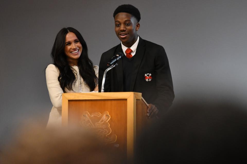 LONDON, ENGLAND - MARCH 06: Meghan, Duchess of Sussex smiles as the student Aker Okoye speaks during a special school assembly at the Robert Clack Upper School in Dagenham ahead of International Women’s Day (IWD) held on Sunday 8th March, on March 6, 2020 in London, England.   (Photo by Ben Stansall-WPA Pool/Getty Images)