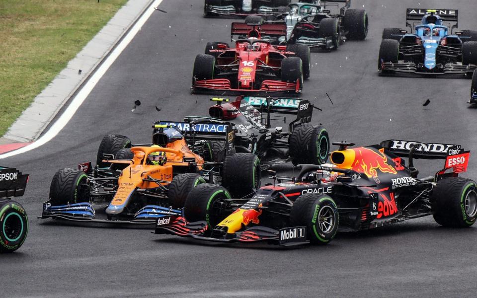 Hungarian Grand Prix - Hungaroring, Budapest, Hungary - August 1, 2021 McLaren's Lando Norris collides with Mercedes' Valtteri Bottas and Red Bull's Max Verstappen - Pool via REUTERS