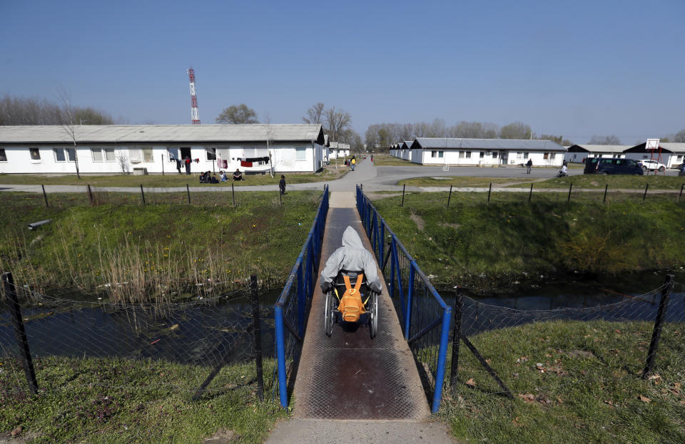 A migrant returns to the barracks after receiving dose of the AstraZeneca vaccine during the vaccination in the "Krnjaca" refugee centre near Belgrade, Serbia, Friday, March 26, 2021. Serbia has started vaccinating migrants as the Balkan country struggles with a new coronavirus outbreak despite a widespread inoculation campaign. (AP Photo/Darko Vojinovic)