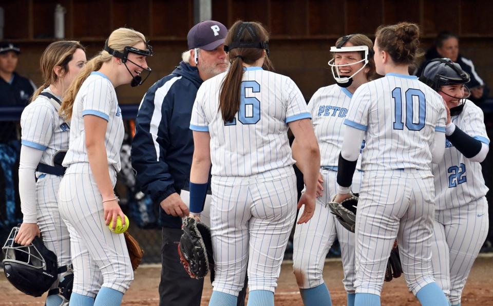 Petoskey head softball coach Brad Hasse lightens things up during a mound visit in the opener against Cadillac Tuesday, which came as a sweep for the Northmen.