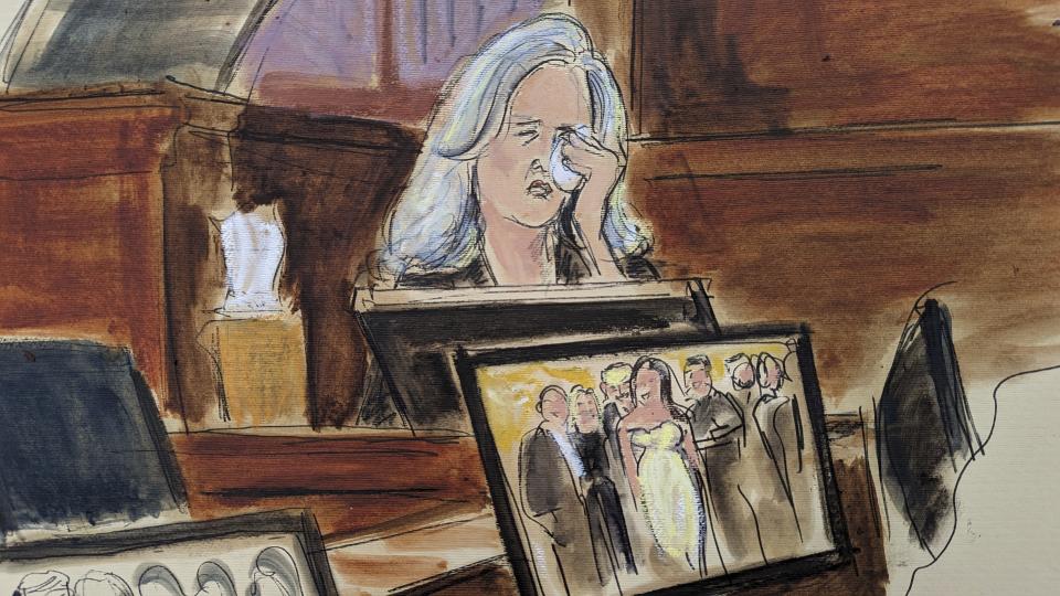 In this courtroom sketch, Natasha Stoynoff weeps on while testifying that Donald Trump pushed himself on to her and made a sexual advance at Mar-a-Lago during her assignment interviewing him and his wife Melania on their one year anniversary, during writer E. Jean Carroll's lawsuit against former President Trump, Wednesday, May 3, 2023, in Manhattan federal court in New York. A photograph of the magazine crew, including Stoynoff, with Donald Trump and Melania is displayed on a computer monitor. Trump has denied that he ever tried to kiss Stoynoff. (Elizabeth Williams via AP)