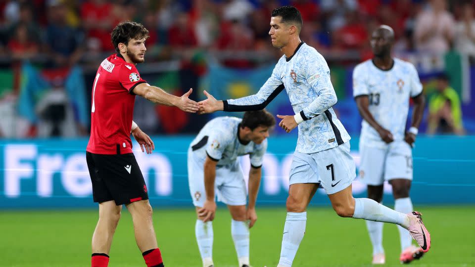 Cristiano Ronaldo shakes hands with Khvicha Kvaratskhelia as he was substituted off in the second half. - Kevin C. Cox/Getty Images