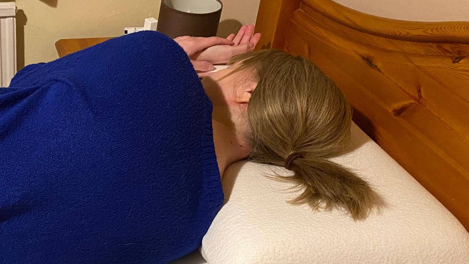 A person lying on the Panda Memory Foam Bamboo Pillow