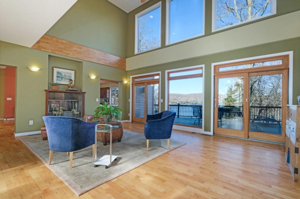 The living room sports floor-to-ceiling windows looking out on the water. Justin P. for Digital Homes