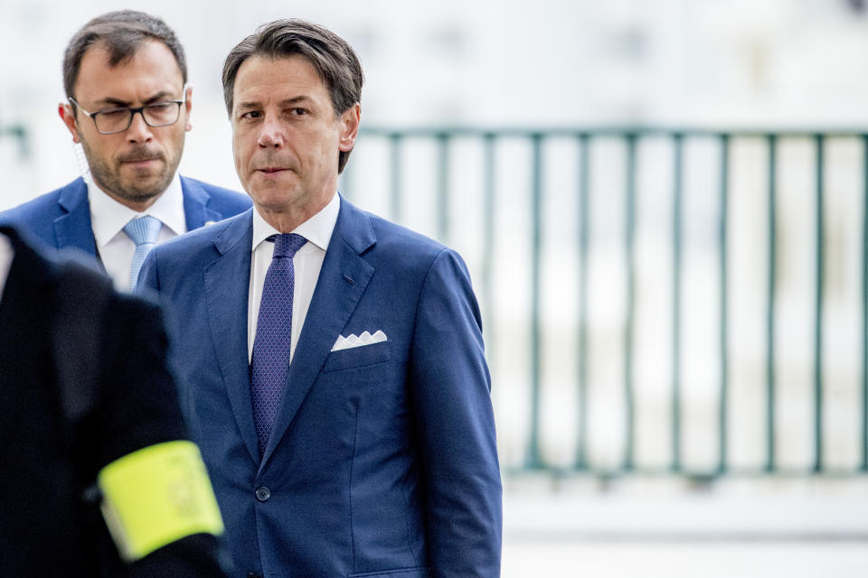 Italian Premier Giuseppe Conte, right, arrives at the G-7 summit in Biarritz, France, Sunday, Aug. 25, 2019. (AP Photo/Andrew Harnik)