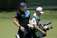 Matt Wallace, left, of England, walks with his caddie David McNeilly to the fourth tee box during the second round of the Travelers Championship golf tournament at TPC River Highlands, Friday, June 26, 2020, in Cromwell, Conn. Wallace is playing the second round by himself after two other golfers in his group, Denny McCarthy and Bud Cauley, withdrew from the tournament. McCarthy told Golfchannel.com that he withdrew from the tournament after feeling sick Thursday night and testing positive for the coronavirus on Friday. Cauley, who played with McCarthy on Thursday, also withdrew before Friday's second round. McCarthy became the third PGA Tour player to test positive for the virus since its restart and the second this week, joining Cameron Champ who withdrew on Tuesday. Nick Watney withdrew just before the second round of last week's RBC Heritage Championship. (AP Photo/Frank Franklin II)