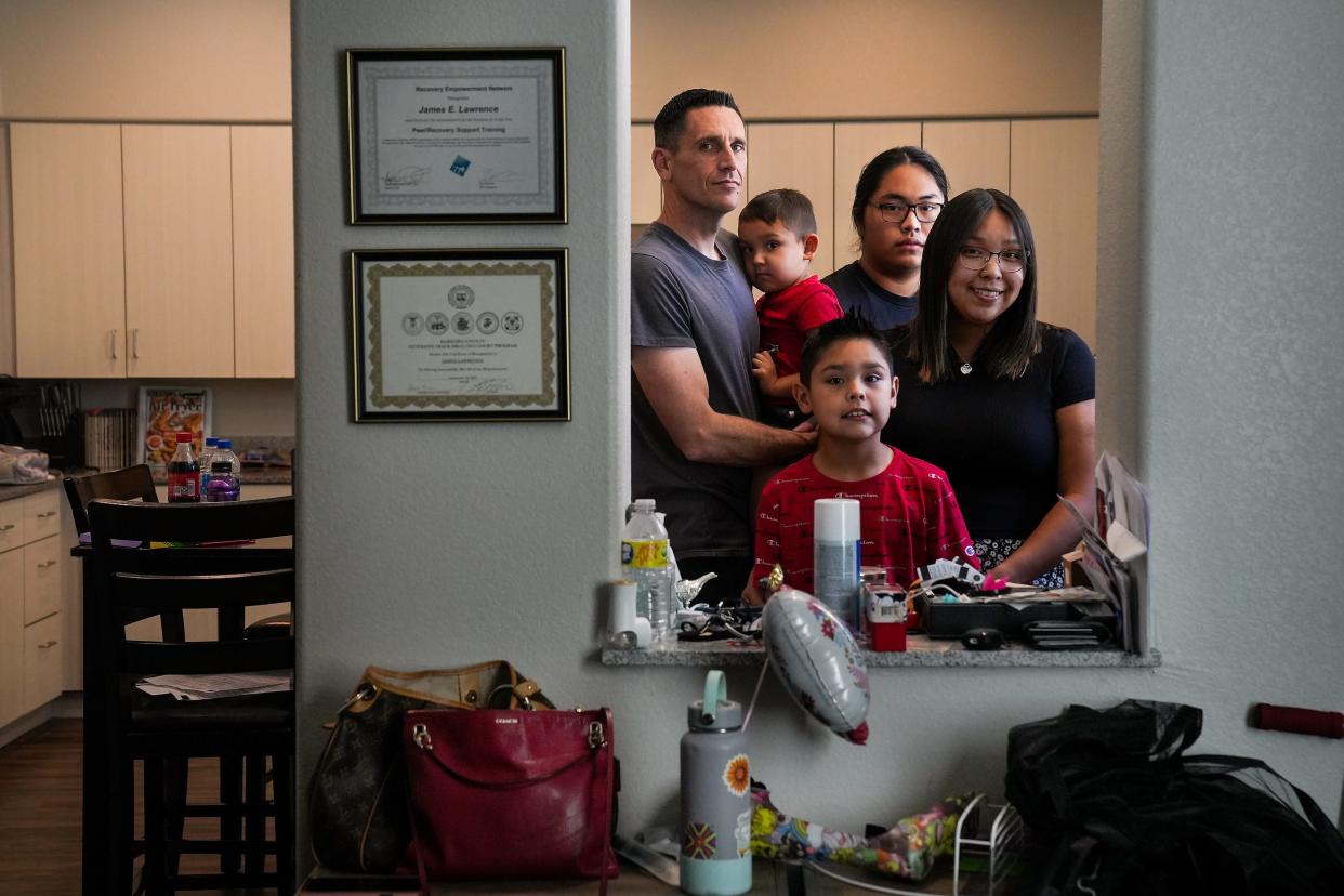 Clockwise from left, James Lawrence, Gabriel, 3, Michael Castillo, Arlinda Whidehat, and Nathaniel, 8, pose for a portrait at their home on Saturday, June 4, 2022, in Phoenix. The couple and brother-in-law rent a three-bedroom and two-bath apartment in downtown Phoenix run by the nonprofit, Native American Connections, and costs them 30% of their income.