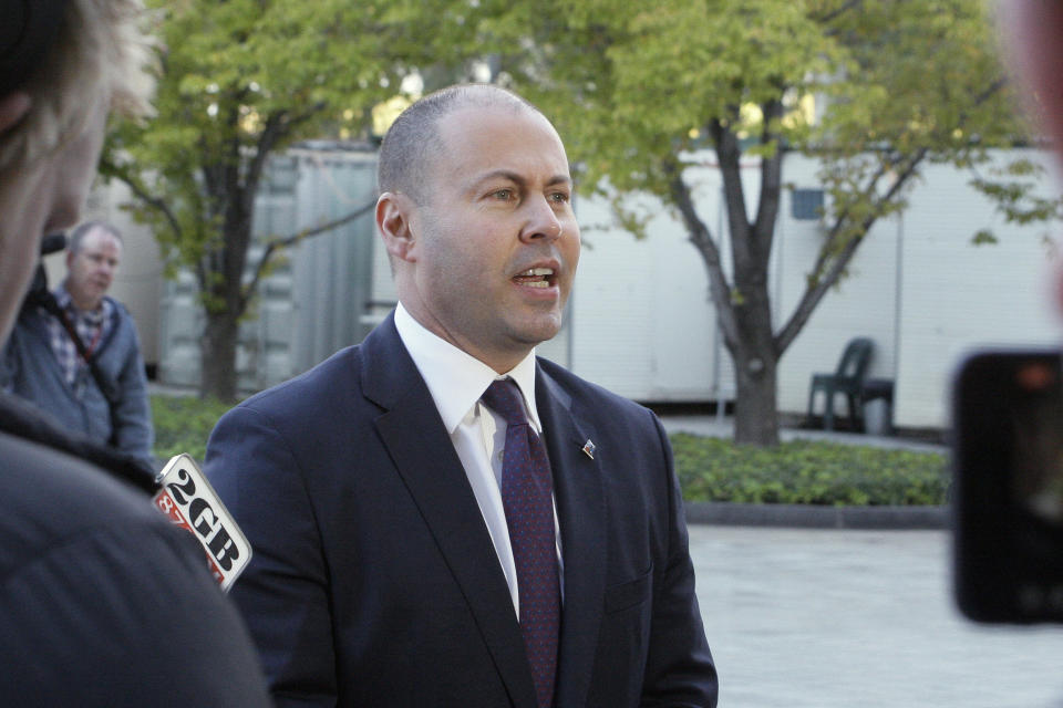 Australian Treasurer Josh Frydenberg addresses the media outside Parliament House in Canberra.