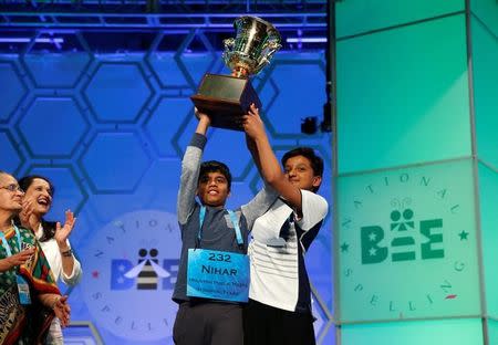 Co-champions Nihar Saireddy Janga and Jairam Jagadeesh Hathwar (R) hold their trophy upon completion of the final round of Scripps National Spelling Bee at National Harbor in Maryland, U.S. May 26, 2016. REUTERS/Kevin Lamarque