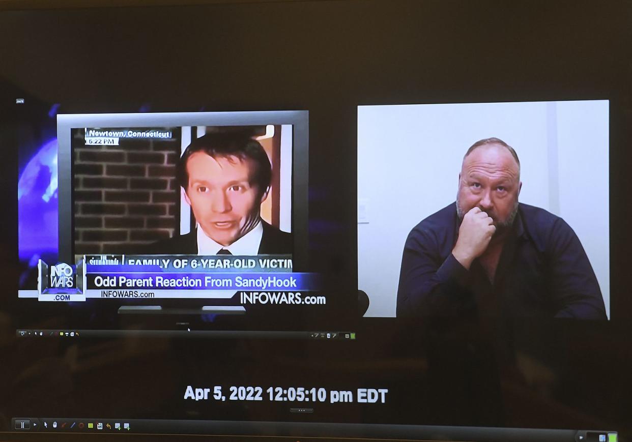 A video of Alex Jones responding to questions about Infowars segments covering the Sandy Hook massacre is presented to the jury panel during Jones' defamation trial at Superior Court in Waterbury, Conn., on Thursday, Sept. 29, 2022. 