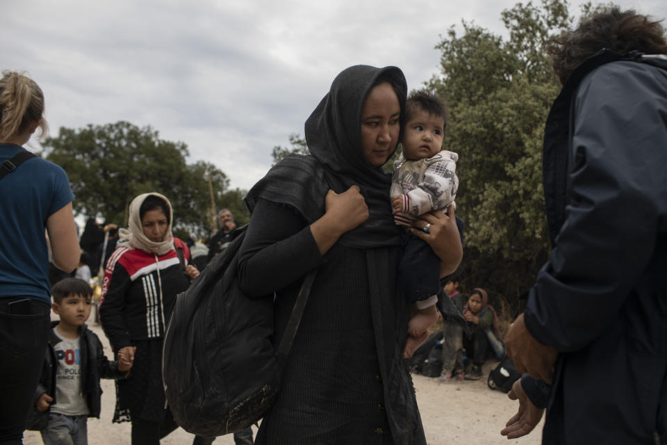 Afghan women with their children arrive with other migrants and refugees after crossing a part of the Aegean Sea, from Turkey to Greece on an overcrowded dinghy, near the town of Madamados on the Greek island of Lesbos, on Monday, Oct. 7, 2019. Authorities in Greece have expanded a program to transfer migrants and refugees from overcrowded camps on the islands to the mainland amid concern that the number of arrivals from nearby Turkey could continue to rise. (AP Photo/Petros Giannakouris)