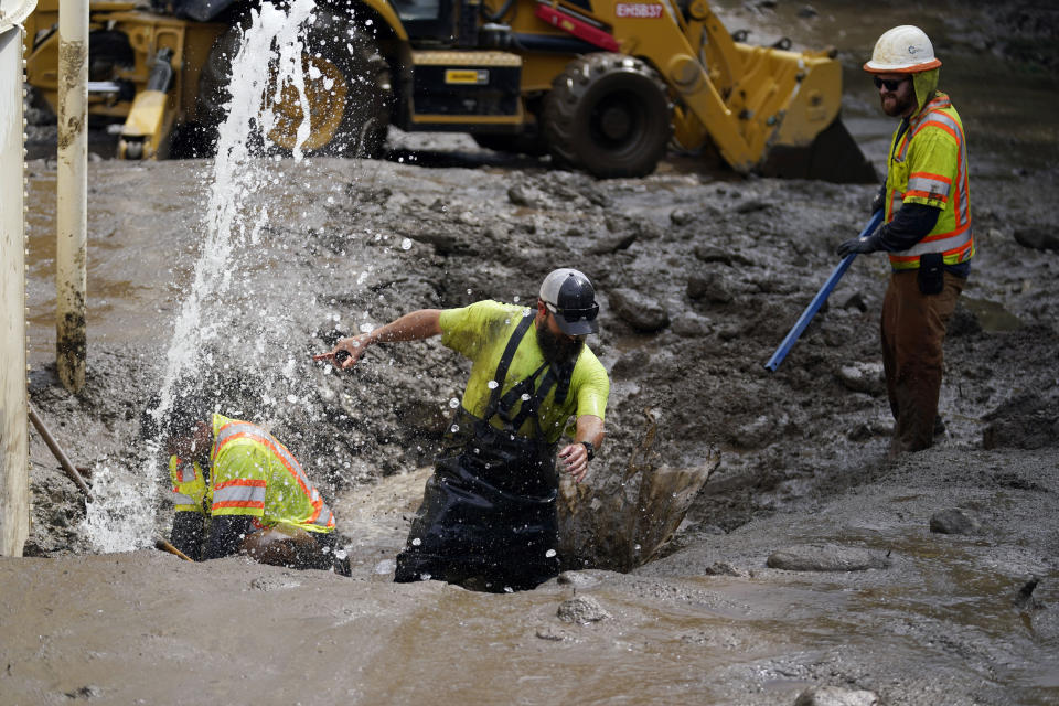 Workers with the Yucaipa Valley Water District work on repairing a reservoir used as a drinking source in the aftermath of a mudslide, Tuesday, Sept. 13, 2022, in Oak Glen, Calif. (AP Photo/Marcio Jose Sanchez)