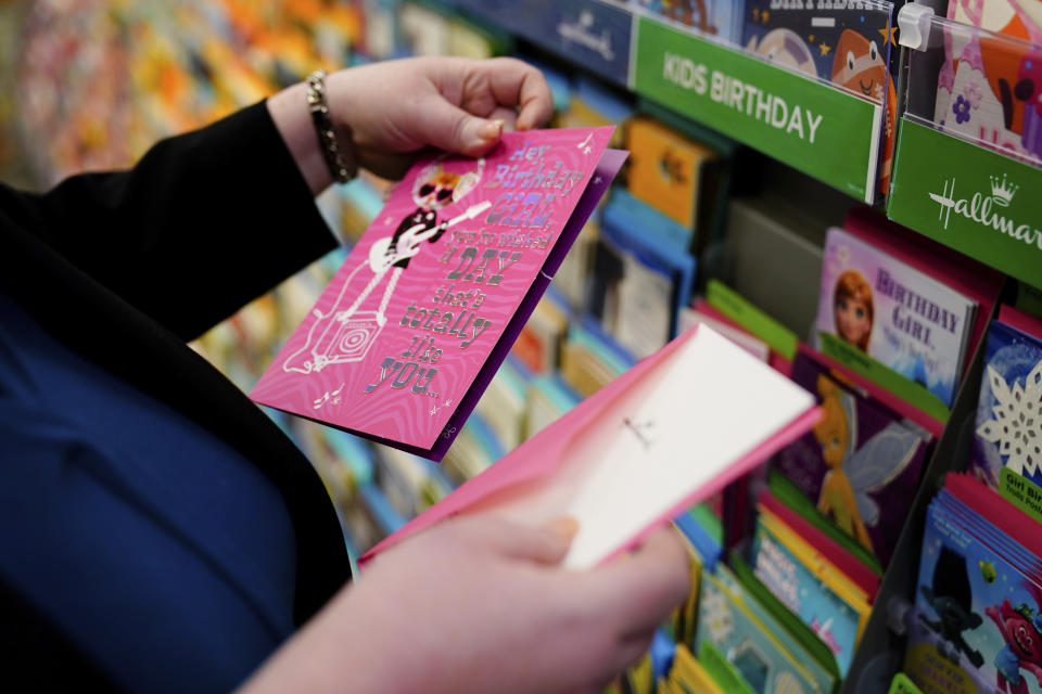 Attorney Robin Frank looks for a birthday card to send to a former client, in Pittsburgh, Thursday, March 17, 2022. A longtime family law attorney, Frank fights for parents at one of their lowest points – when they risk losing their children. (AP Photo/Matt Rourke)