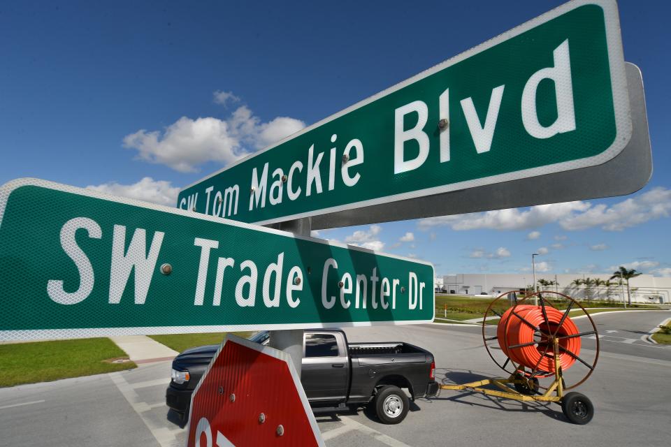 A contractor passes through the intersection SW Trade Center Drive and SW Tom Mackie Boulevard in Port St. Lucie on Thursday, Nov. 30, 2023. Businesses such as TAMCO Group, which manufactures and distributes lighting and electrical products, and Accel International Holdings Inc. (background) that will manufacture high-performance cables, wires, and conductors, have built facilities on SW Mackie Boulevard. St. Lucie County has received nearly $64 million from the American Rescue Plan Act, with Port St. Lucie investing $5.9 million from the ARPA funding to bring jobs to SW Tom Mackie Blvd., a jobs corridor west of Interstate 95 and east of SW Village Parkway.