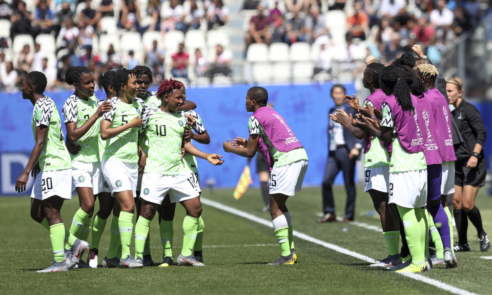 Nigeria players celebrate after taking the lead after South Korea's Kim Do-yeon scored an own goal during the Women's World Cup Group A soccer match between Nigeria and South Korea in Grenoble, France, Wednesday June 12, 2019.(AP Photo/Laurent Cipriani)