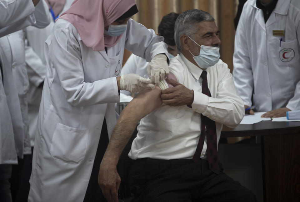 Palestinian Health Ministry official Yahya Aabed, receives a shot of the COVID-19 Russian-made Sputnik V vaccine, in Gaza City, Monday, Feb. 22, 2021. (AP Photo/Khalil Hamra)