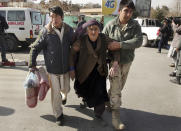 <p>An wounded elderly woman is assisted at the site of a deadly suicide attack in the center of Kabul, Afghanistan, Saturday, Jan. 27, 2018. (Photo: Massoud Hossaini/AP) </p>