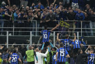 Inter Milan's Lautaro Martinez, centre, celebrates after scoring his side's opening goal during the Champions League semifinal second leg soccer match between Inter Milan and AC Milan at the San Siro stadium in Milan, Italy, Tuesday, May 16, 2023. (AP Photo/Antonio Calanni)