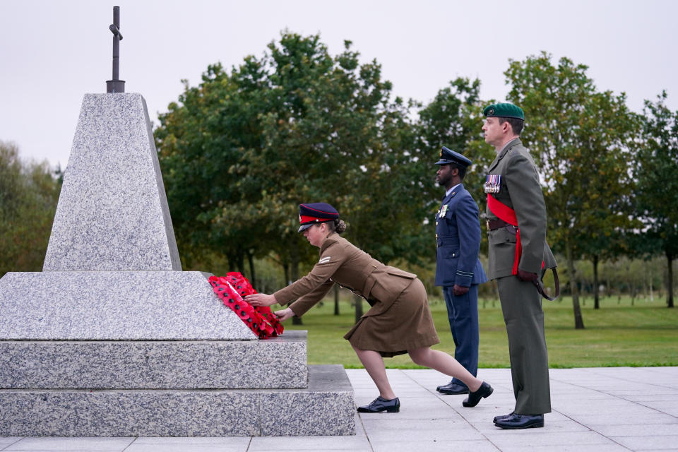<p>Members of the Armed Forces lay a wreath at the Camp Bastion Memorial, during a service to mark 20 years since the start of UK operations in Afghanistan at the National Memorial Arboretum, Alrewas, near Lichfield, Staffordshire. Picture date: Thursday October 7, 2021.</p>
