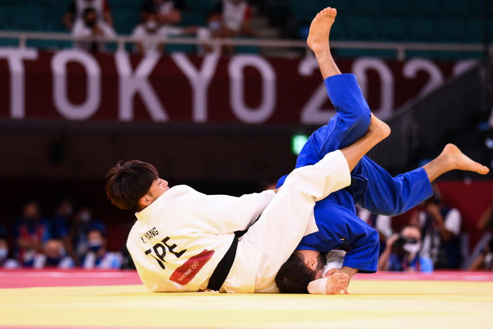 Taiwan's Yang Yung Wei (white) competes with France's Luka Mkheidze during their judo men's -60kg semifinal A bout during the Tokyo 2020 Olympic Games at the Nippon Budokan in Tokyo on July 24, 2021. (Photo by Franck FIFE / AFP) (Photo by FRANCK FIFE/AFP via Getty Images)