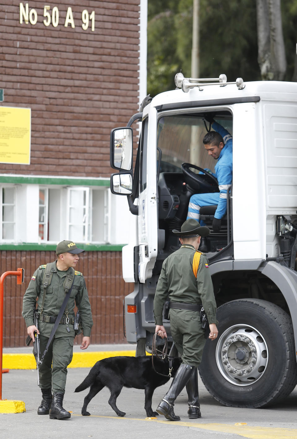 Police inspect a truck outside the General Francisco de Paula Santander Police Academy a day after a car bomb exploded at the site, in Bogota, Colombia, Friday, Jan. 18, 2019. Colombia blames the National Liberation Army, ELN, rebels for the deadly attack that left more than 20 dead and wounded many others. (AP Photo/John Wilson Vizcaino)