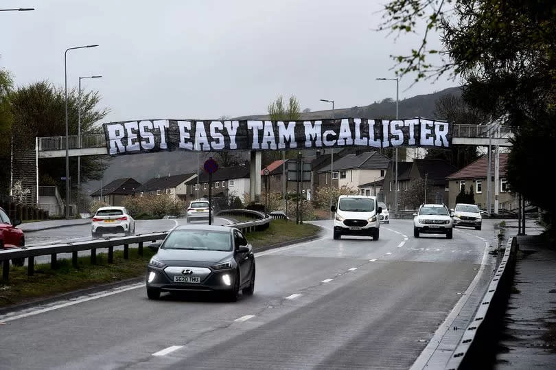 A banner that reads "Rest East Tam McAllister" has been displayed on Great Western Road