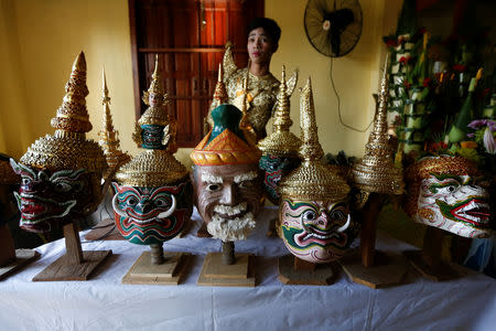 A dancer gets ready before a performance of masked theatre known as Lakhon Khol which was recently listed by UNESCO, the United Nations' cultural agency, as an intangible cultural heritage, along with neighbouring Thailand's version of the dance, known as Khon at the Wat Svay Andet buddhist temple in Kandal province, Cambodia, December 16, 2018. REUTERS/Samrang Pring