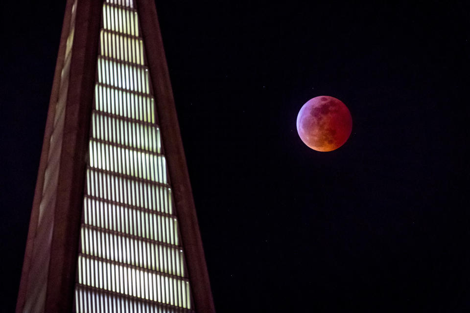 The super blood wolf moon rises behind the Transamerica Pyramid in San Francisco, Jan. 20.