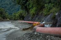 Sandbags are seen piled up against a damaged oil pipeline in the Ecuadorian Amazon