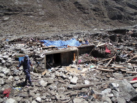 Soldiers search for bodies after a massive avalanche triggered by last week's earthquake overwhelmed Langtang village, Nepal, in this May 2, 2015 police handout photo. Rescue workers are struggling to recover the bodies of nearly 300 people, including about 110 foreigners, believed to be buried under up to six metres (20 feet) of ice, snow and rock from the landslide that destroyed Langtang village. Picture taken May 2, 2015. REUTERS/Handout via Reuters ATTENTION EDITORS - NO SALES. NO ARCHIVES. FOR EDITORIAL USE ONLY. NOT FOR SALE FOR MARKETING OR ADVERTISING CAMPAIGNS. THIS PICTURE WAS PROVIDED BY A THIRD PARTY. REUTERS IS UNABLE TO INDEPENDENTLY VERIFY THE AUTHENTICITY, CONTENT, LOCATION OR DATE OF THIS IMAGE. THIS PICTURE IS DISTRIBUTED EXACTLY AS RECEIVED BY REUTERS, AS A SERVICE TO CLIENTS