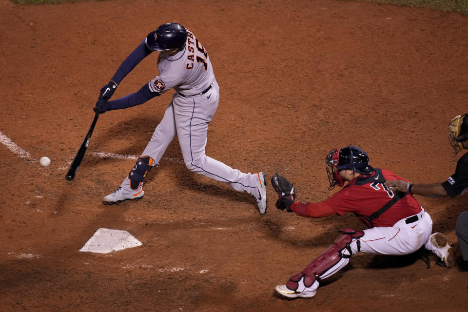 Houston Astros' Jason Castro hits a RBI-single against the Boston Red Sox during the ninth inning in Game 4 of baseball's American League Championship Series Tuesday, Oct. 19, 2021, in Boston. (AP Photo/Charles Krupa)