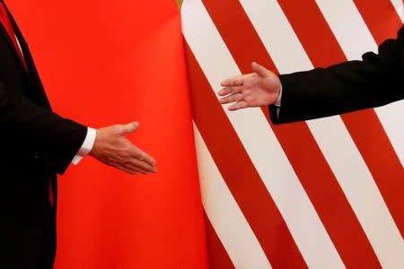 FILE PHOTO: U.S. President Donald Trump and China's President Xi Jinping shake hands after making joint statements at the Great Hall of the People in Beijing, China, November 9, 2017. REUTERS/Damir Sagolj/File Photo