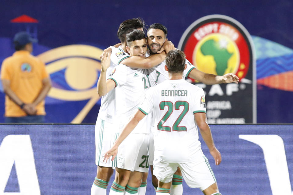 Algeria's Riyad Mahrez celebrates with his teammates after scoring his team's second goal during the African Cup of Nations round of 16 soccer match between Guinea and Algeria in 30 June stadium in Cairo, Egypt, Sunday, July 7, 2019. (AP Photo/Ariel Schalit)