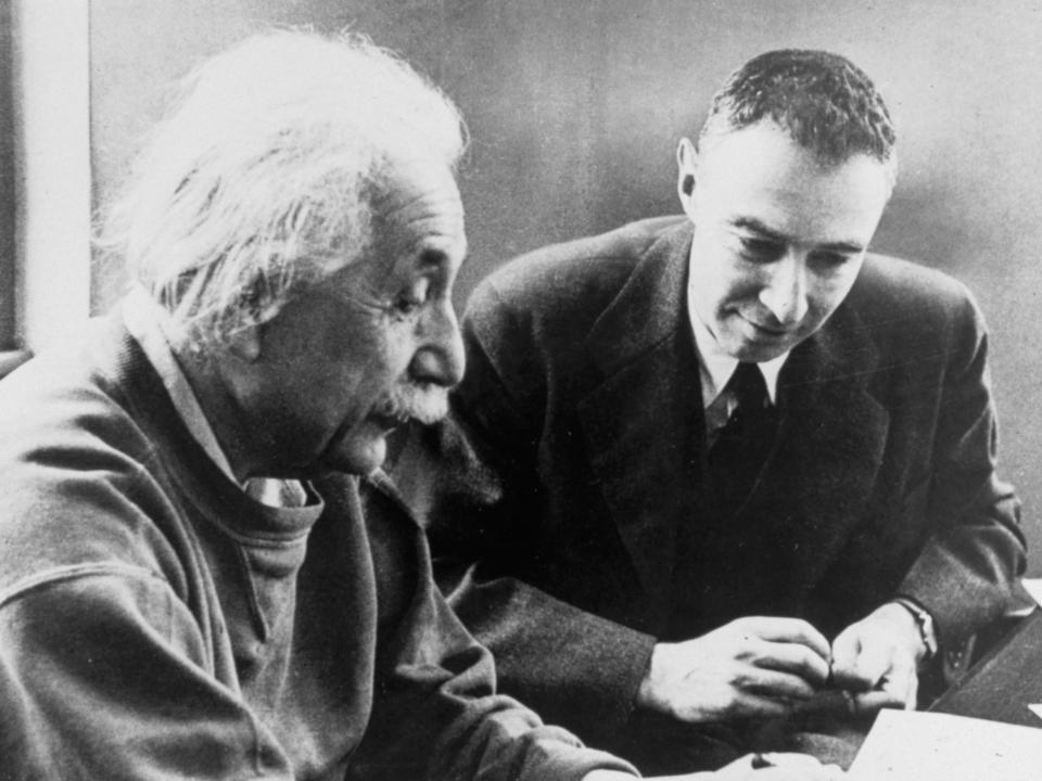 A black and white photo of J. Robert Oppenheimer with Albert Einstein.