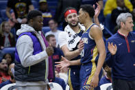 New Orleans Pelicans forward Zion Williamson, left, and forward Larry Nance Jr., center, congratulate guard Trey Murphy III (25) after Murphy reached 1000 career points in the second half of an NBA basketball game against the Sacramento Kings in New Orleans, Sunday, Feb. 5, 2023. (AP Photo/Matthew Hinton)