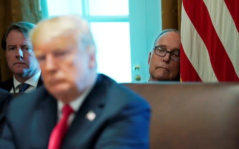 White House Counsel Donald McGahn (L) and White House economic advisor Larry Kudlow (R) listen behind President Donald Trump  - Credit: Reuters