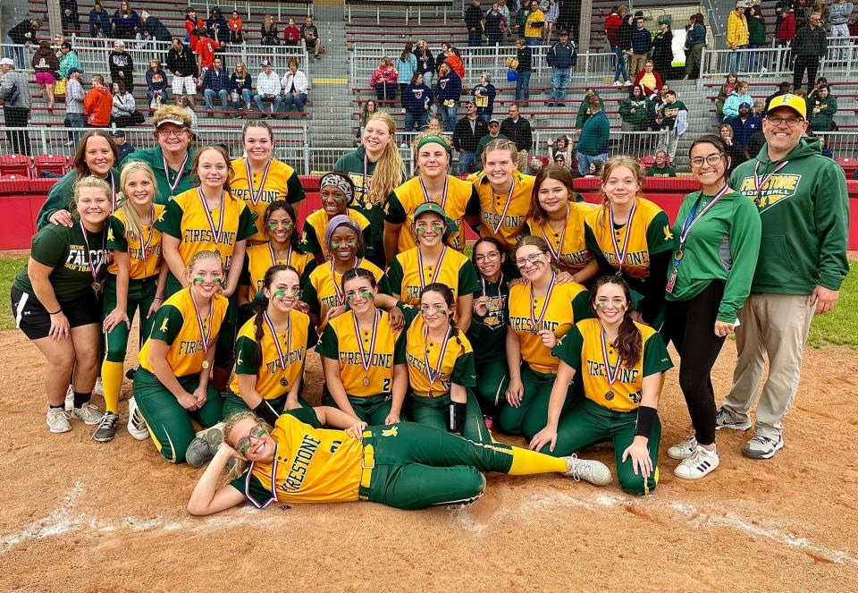 Players and coaches from the Firestone softball team smile for pictures Monday after earning a 9-2 win over Ellet in the City Series postseason championship game at Firestone Stadium.