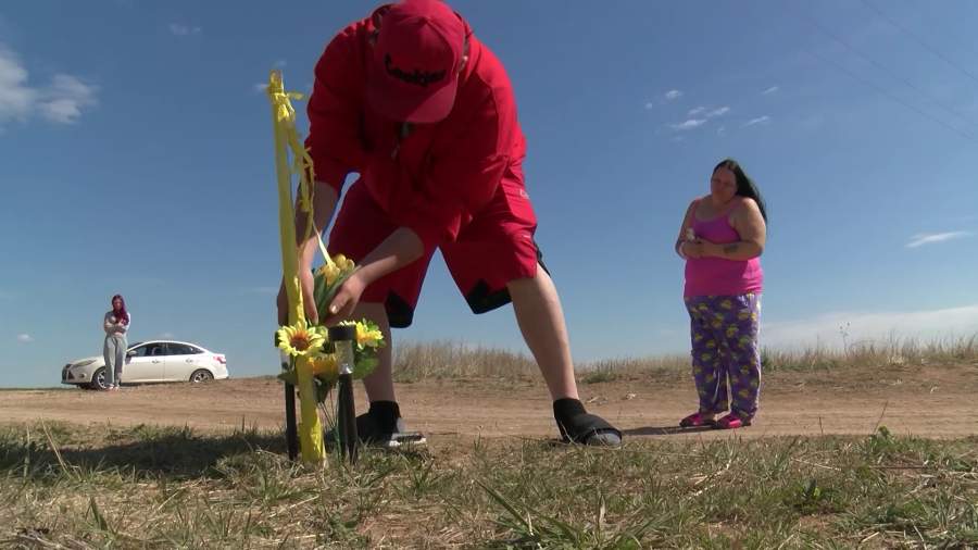 People from Hugoton stopping by to drop off flowers for a location marked with the yellow ribbons for Veronica Butler and Jilian Kelley on April 10, 2024 (KSN Photo)