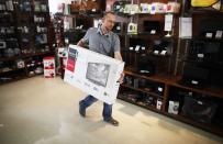 <h2>Stocking shelves in Zenica</h2>Kerim Sacak, a 29 year-old sales and delivery person, carries an LCD screen in Tehnomax computer shop in Zenica, May 11, 2012. Sacak studied for four years at Sarajevo University where he received a police degree. For the last four years he has tried to find a job as a police officer but has been working in sales and delivery for three years. Picture taken May 11, 2012.