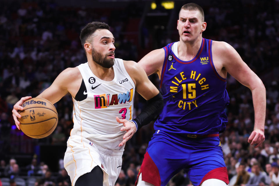 Miami's Max Strus drives against Denver's Nikola Jokić  during a game on Feb.  13, 2023 in Miami.  The teams meet in the 2023 NBA Finals, beginning Thursday.  (Megan Briggs/Getty Images)