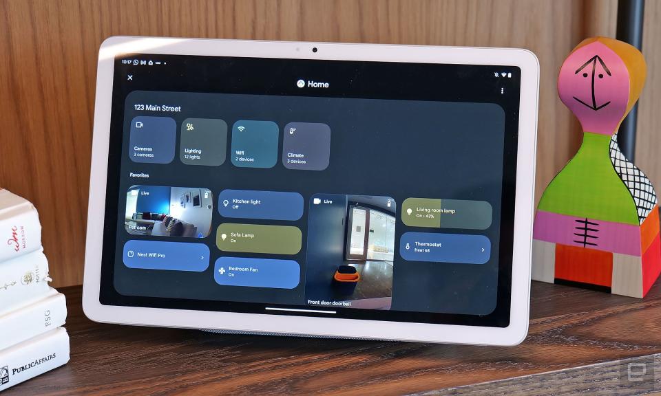 The Hub Mode smart home controls dashboard on the Pixel Tablet, showing four square buttons at the top followed by eight blocks below. Two of these rectangles contain feeds from security cameras, while another two are controls for lamps.