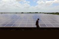 A engineer walks past the solar panels at the Benadir Electricity Company (BECO) solar project in Mogadishu