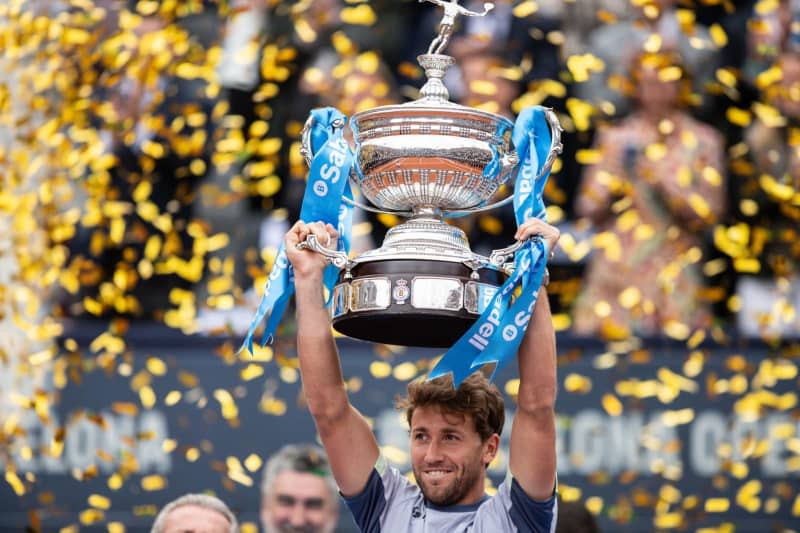 Norwegian tennis player Casper Ruud celebrates with the trophy after defeating Greece's Stefanos Tsitsipas during their men's singles final match of the Barcelona Open tennis tournament. Marti Segura Ramoneda/ZUMA Press Wire/dpa