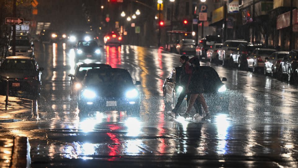 People cross the street in the rain in San Francisco on February 18. - Tayfun Coskun/Anadolu/Getty Images