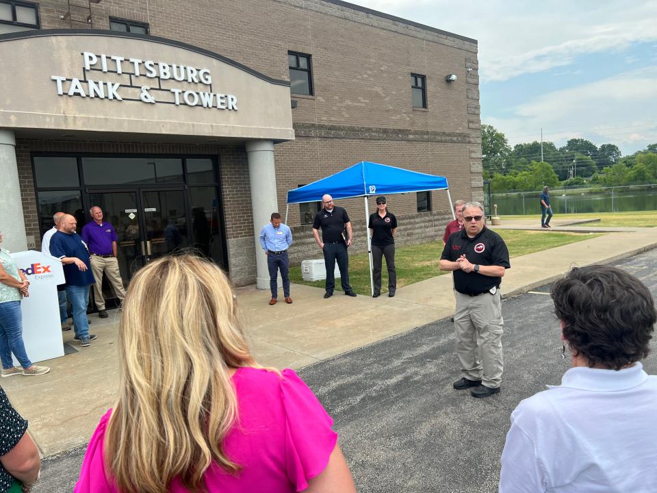 Kenny Garrett (center right), director of the Henderson County Office of Emergency Management, speaks to a crowd of employees and community members outside the headquarters of Pittsburg Tank & Tower Group on July 8. The company had been designated as a Weather-Ready Nation Ambassador as part of a national pilot project to have Henderson County certified as a National Weather Service Weather-Ready Community.