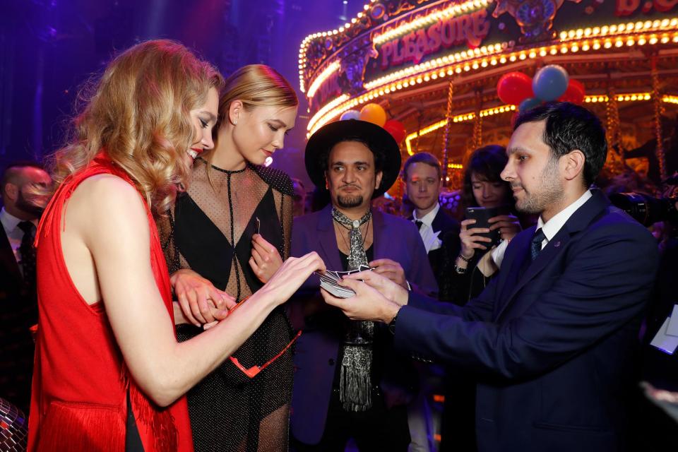 Natalia Vodianova with Karlie Kloss is shown a magic trick by Dynamo at the Fabulous Fund Fair in support of The Naked Heart Foundation in 2017 (Dave Benett/ Getty Images for The Naked Heart Foundation)