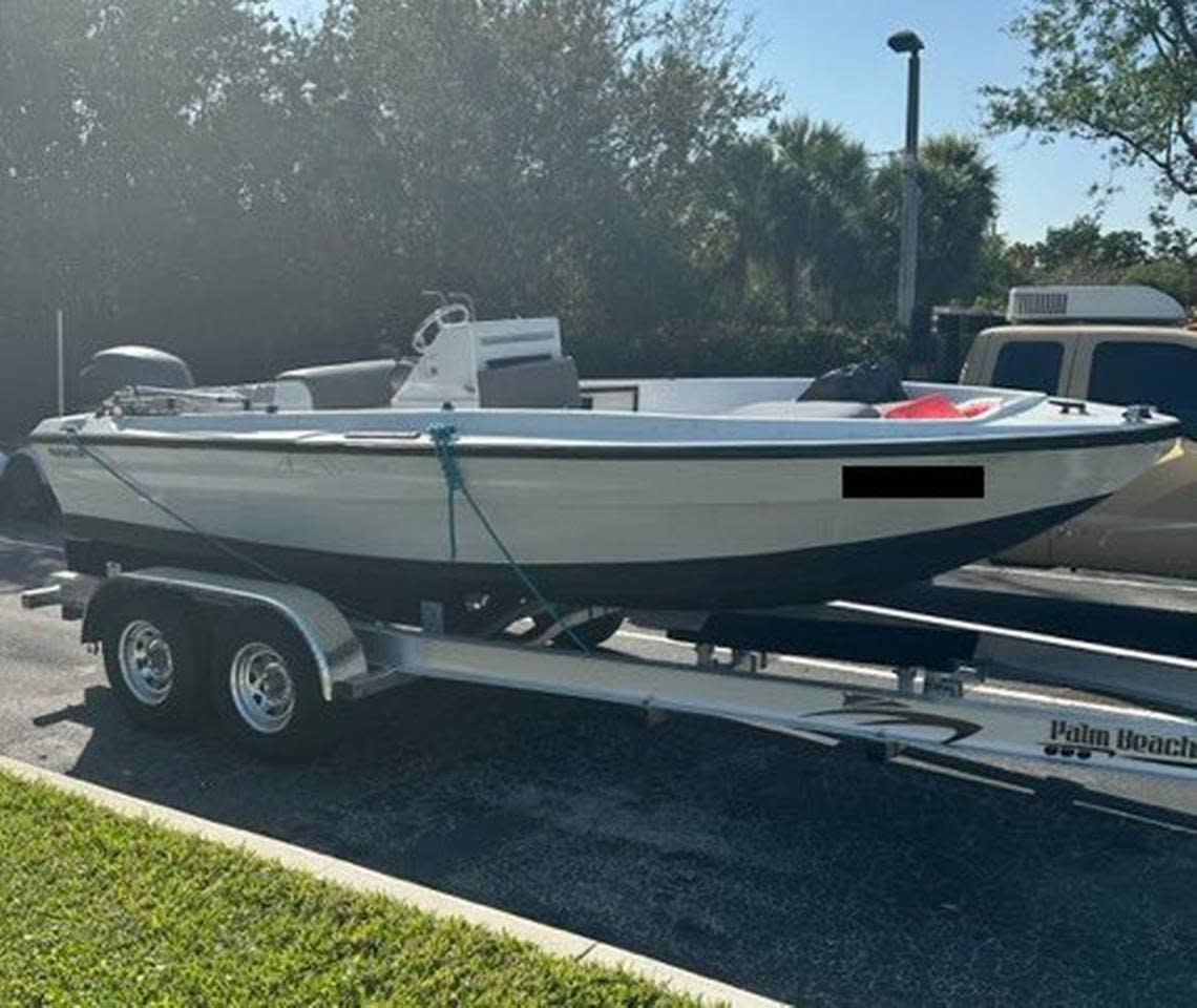 A single-engine center console boat is parked on a trailer near Haulover Beach on Sunday, March 5, 2023. The U.S. Border Patrol said three people from the Republic of Georgia were on the vessel.