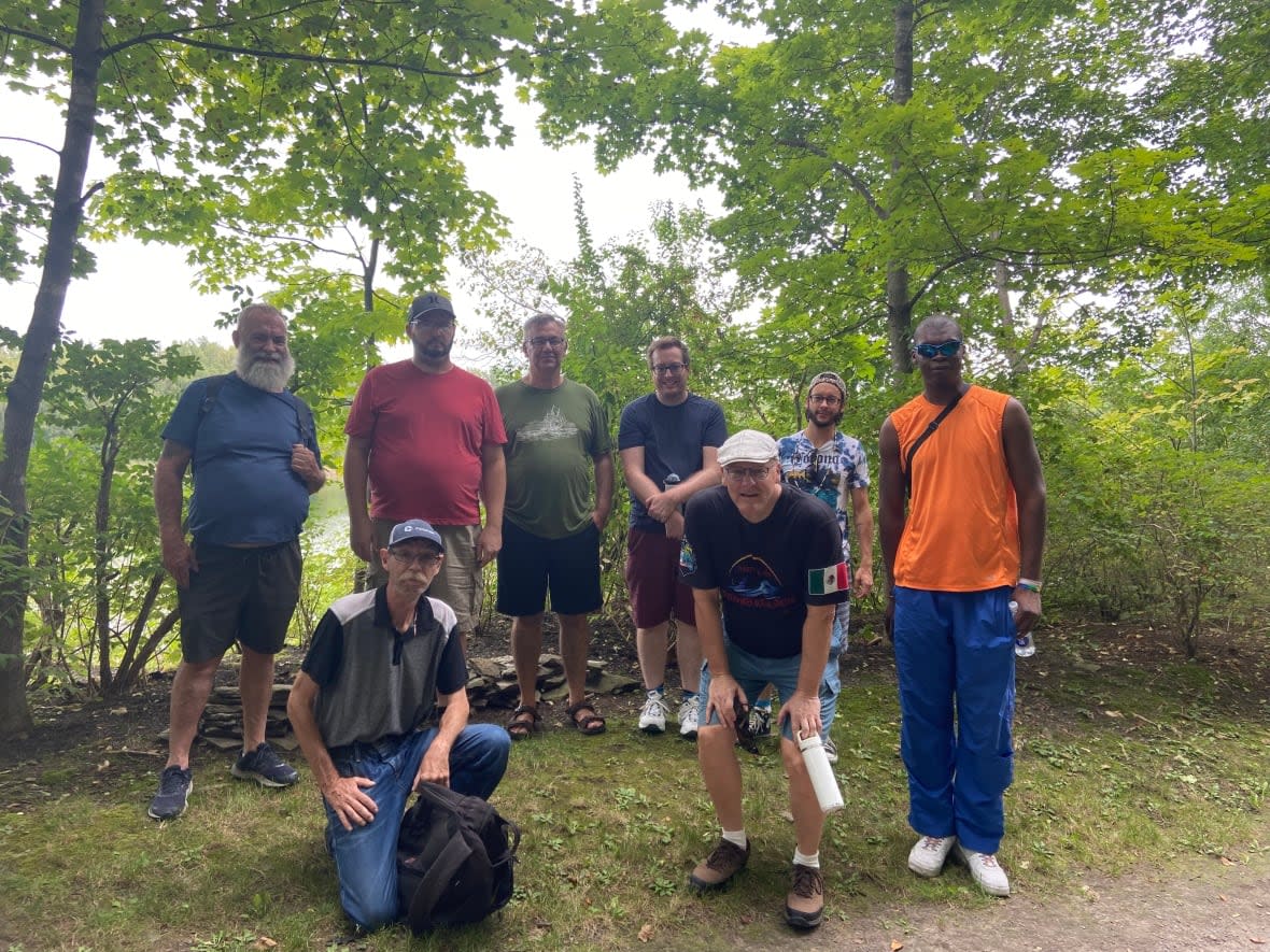 Members of the outdoor 'bears' walking group pose during one of their walks in Rockcliffe Park.  (Anchal Sharma/CBC - image credit)